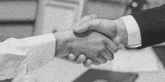 Close-up of a handshake between two people, symbolizing a business agreement or partnership.